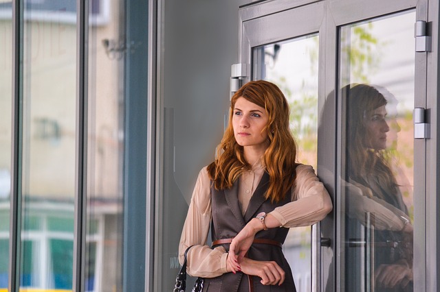 Image of a woman holding back a door.