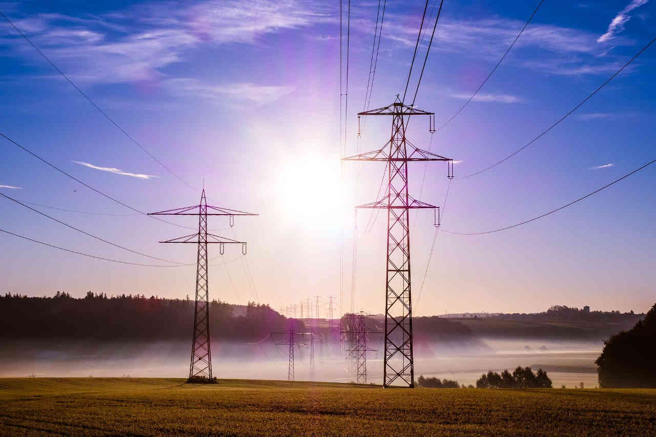 Image of powerlines cutting through a meadow