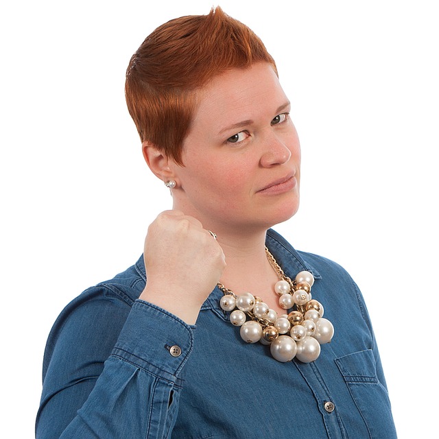 Image of a woman holding a fist up in a threatening manner